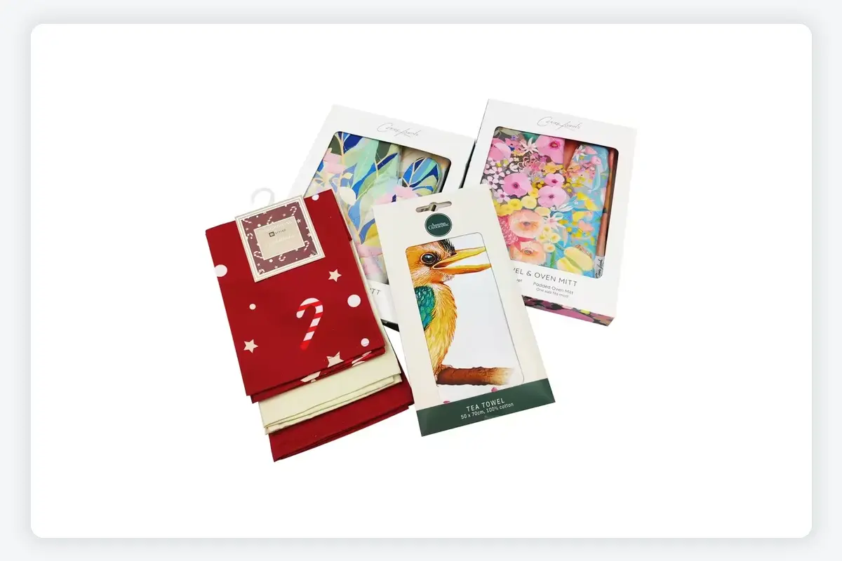Printed kitchen towel samples presented with coordinated cards and gift-style presentation boxes