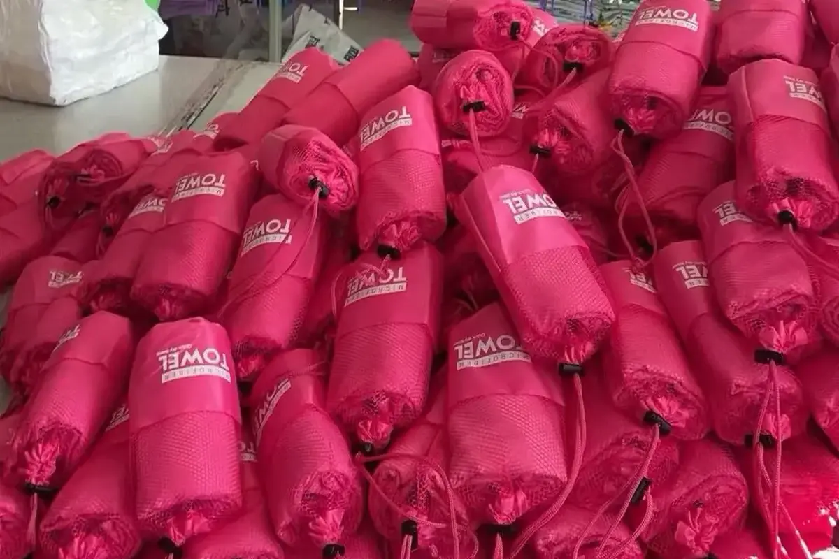 Pink rolled towels with contrasting branded packaging for color presentation
