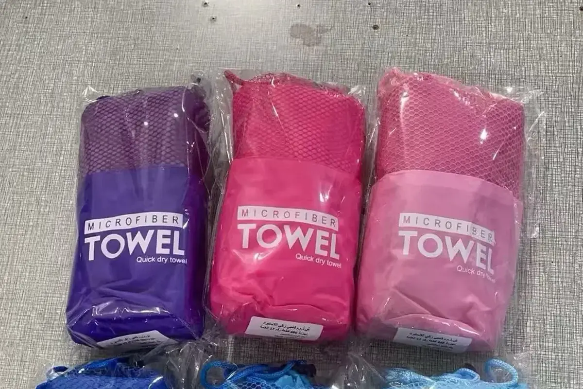 Three packaged microfiber towel samples in different colors
