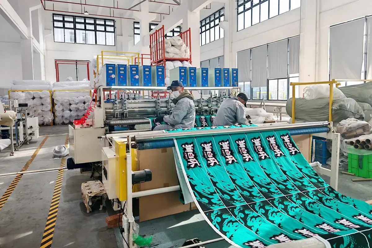 Custom printed towel panels with repeat artwork moving through a production line